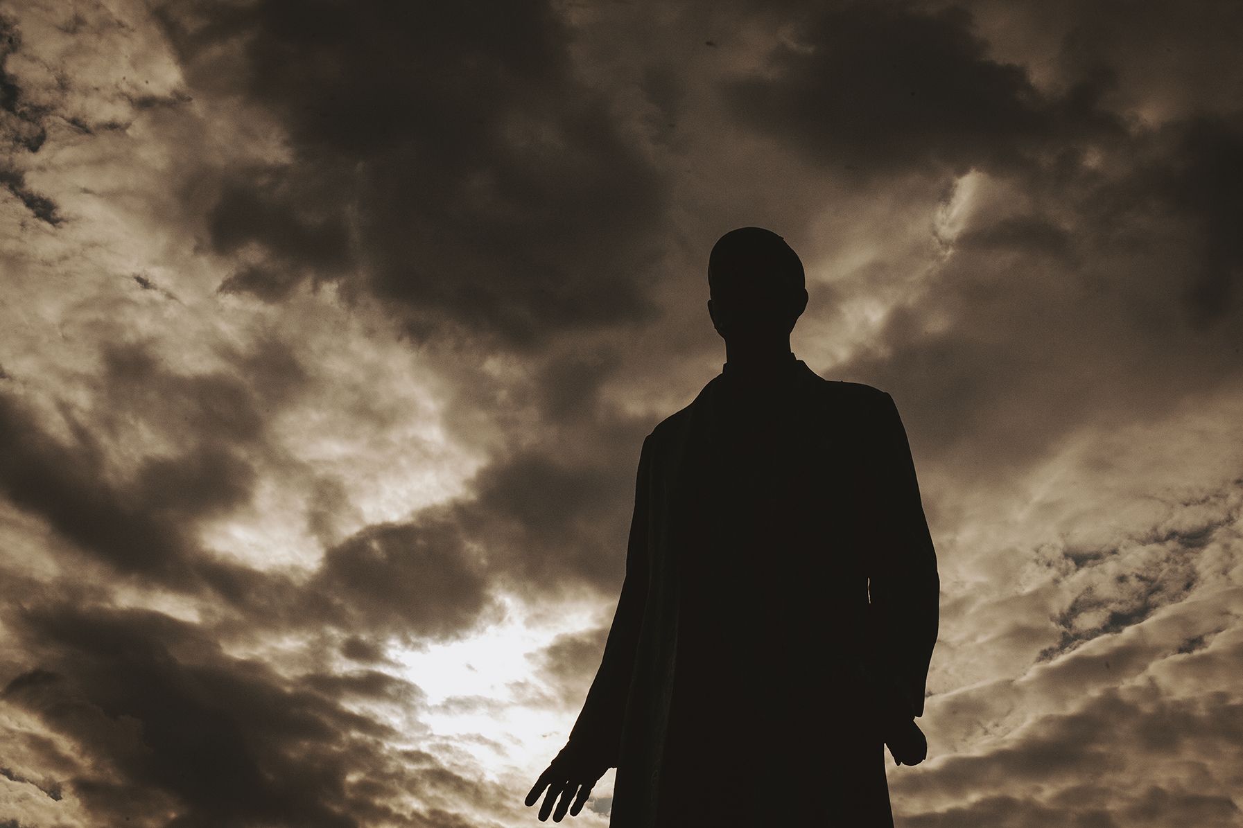 Image (shadow of a man with clouds on the background)